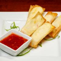 Shrimp Wontons · Our spin on the Crab Rangoon.  Creamy shrimp mixture in a flaky Asian wrap.  Served with swe...