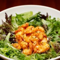 Firecracker Shrimp · Sweet and Spicy battered shrimp, fried to a golden brown and served on a bed of greens.