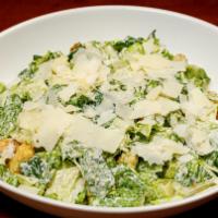 Caesar Salad · Romaine hearts tossed in caesar dressing with croutons and Parmesan cheese.