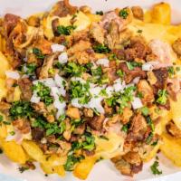 Asada Fries · French fries smothered in hot nacho cheese, crispy bacon, fajita meat topped with cilantro a...