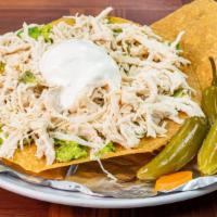 Tostada Siberia · Shredded chicken on a hard shell tortilla topped with sour cream, guacamole and topped with ...