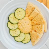 Hummus · Served with warm pita and cucumber.