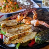 Parrillada Mixta (1) · Beef & Chicken Fajitas, Grilled shrimp and spicy sausage. Served with rice, refried beans, p...