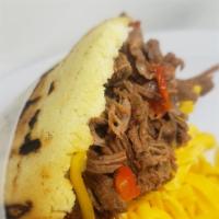Carne Mechada · Shredded beef in juicy onions and peppers sauce.