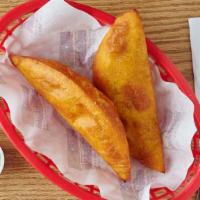 Pollo · one fried empanada with Shredded chicken in juicy tomatoes and peppers sauce.