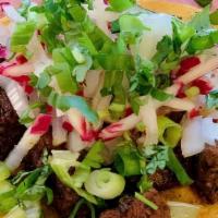 Skirt Steak Taco · Onions, scallions. cilantro and radishes on corn tortilla.