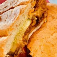 Carnitas Torta · Mexican Bun, Carnitas (Pork), Butter Spread, Bean spread, Guacamole spread, Mozzarella chees...