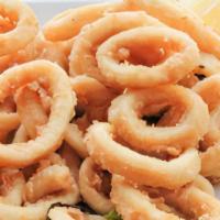 Calamares Fritos · Buttered and fried served with roasted tomatoes, bell pepper and cilantro sauce.