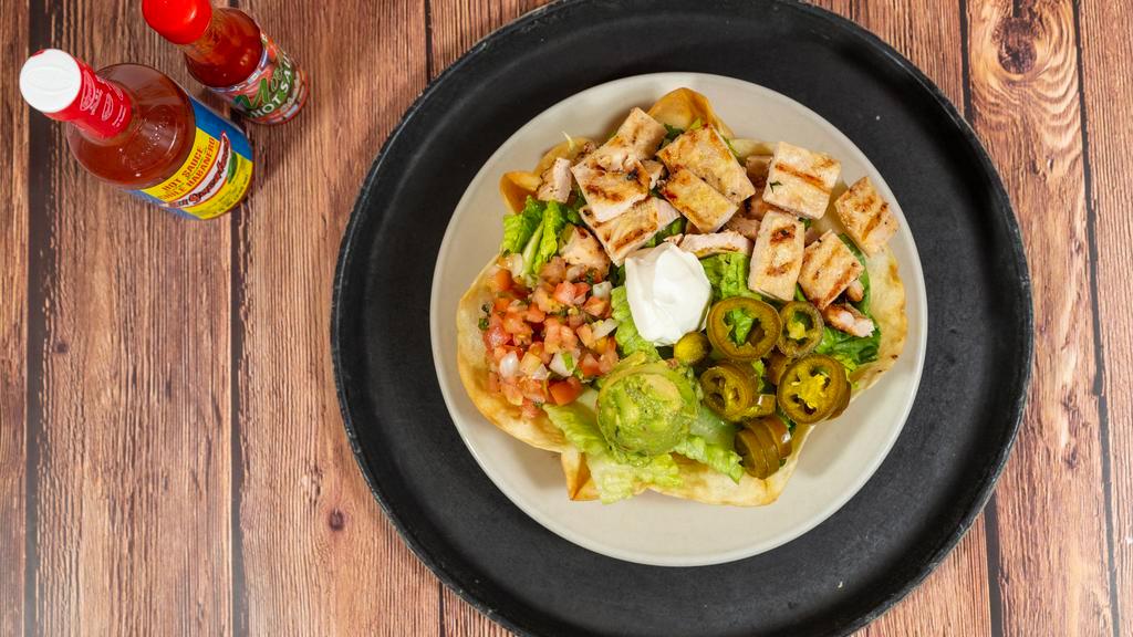Taco Salad · Crispy tortilla shell filled with white rice, black beans, guacamolc, pico de gallo and sour cream.