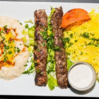 Kafta Kabab · Spiced and marinated ground beef and lamb skewers topped with lettuce, tomatoes, Mezze's hom...