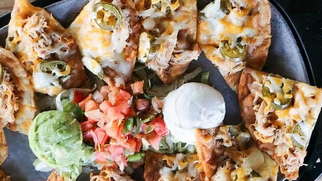 Nachos Tejanos - Fajitas · Tostada chips topped with Certified Angus fajita beef, refried beans, cheddar cheese and pickled jalapeño. Served with sour cream, guacamole and pico de gallo