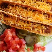 Tacos Crispy · Three crispy corn tortilla shells with seasoned ground beef, lettuce, cheddar cheese, tomato...