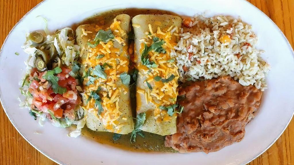 Enchiladas Pork · Slow-roasted chipotle pork, cilantro and onion, your choice of sauce: chile verde, green chile deluxe or chile con queso. Served with green chile rice & refried beans (or substitute mashed black beans.)