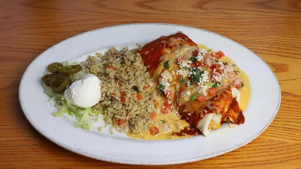 Burrito Fajita Chicken · Flour tortilla stuffed with refried beans, fajita chicken,  Monterey Jack and cheddar cheeses and your choice of filling. Topped with sauce, chile con queso, pico de gallo and queso fresco. Served with green chile rice, sour cream, pickled jalapeño and pico de gallo