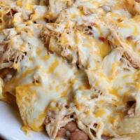 Kid Nachos · Homemade chips layered with refried beans and jack and cheddar cheeses.