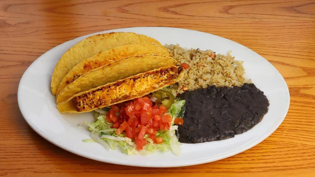 Tacos Crispy [Vegetarian] · Three crispy corn tortilla shells with lettuce, cheddar cheese, tomato and pickled jalapeño. Your choice of vegan taco meat or vegan green chile chick'n