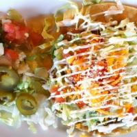 Ala Carte Tostada Refried Beans · Ala Carte crispy corn tortilla layered with refried beans, Monterey Jack and cheddar cheeses...