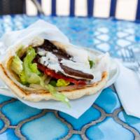 Gyro (Deluxe) · Beef and lamb with lettuce, tomatoes, onions, and cucumber sauce wrapped in toasted pita bre...