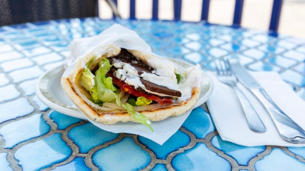 Gyro (Deluxe) · Beef and lamb with lettuce, tomatoes, onions, and cucumber sauce wrapped in toasted pita bread.