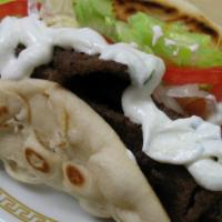 Gyro (Sandwich) · Beef and lamb with lettuce, tomatoes, onions, and cucumber sauce wrapped in toasted pita bre...