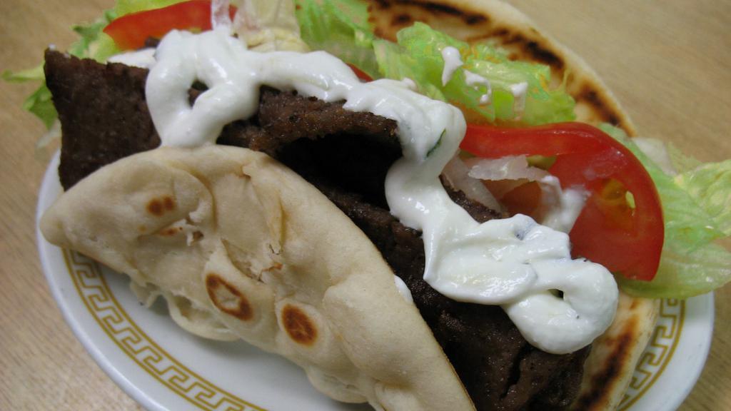 Gyro (Sandwich) · Beef and lamb with lettuce, tomatoes, onions, and cucumber sauce wrapped in toasted pita bread.