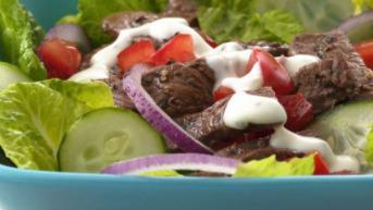 Gyro Salad · Grilled slices of gyro meat served on a bed of romaine lettuce with tomatoes, kalamata olive...
