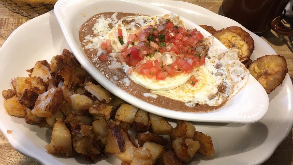 Huevos Rancheros · Consuming raw or undercooked meats, poultry, seafood, shellfish, or egg may increase your risk of foodborne illness, especially if you have certain medical conditions. 
 

Refried beans, two eggs over-medium, cheese, pico de gallo, home fries and tortillas.