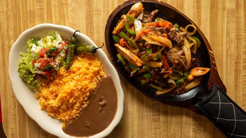 Chicken Fajitas · Grilled chicken with onions, tomatoes and peppers.    Served with side salad, rice, beans, and tortillas.