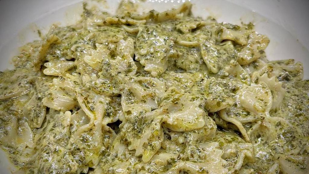 Individual Farfalle In Pesto · bow tie shaped pasta served in a light basil pesto sauce, and shaved parmesan