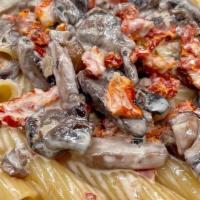 Individual Rigatoni Alla Toscana · Sundried tomatoes, wild mushrooms, brandy and parmesan cheese in a cream sauce