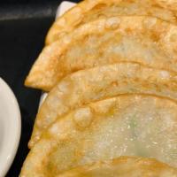 Goon Madnu - Fried Dumpling · Homemade pan-fried dumplings.
(dumpling ingredients: beef, pork  and vegetable)