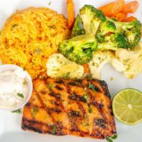 Grilled Salmon · Salmon a la parrilla 10 oz. Served with Mexican rice and vegetables. Servido con arroz mexic...