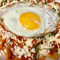 Chilaquiles · corn tortilla chip,tossed with red,or green sauce.,served ,with sour cream,queso fresco,onio...
