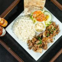 Chicken Shawarma Platter · Chicken, rice, house salad, tahini and garlic sauce. Served with pita bread.
