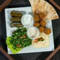 Mezza Sampler Platter · Falafel, grape leaves, hummus, and taboule. Served with pita bread.