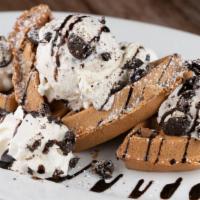 Oreo Waffle · Oreo waffle topped with scoop of cookies & cream ice cream, drizzled with chocolate syrup.