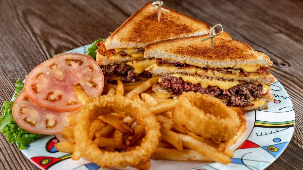 Big Daddy Burger · Twin grilled cheese sandwiches stacked above & below our 8 oz. bacon burger, topped with onion rings.