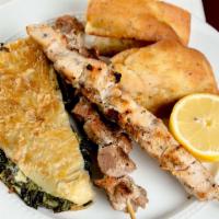 Trio Style Plate · One wood skewered pork kabob, one wood skewered chicken kabob & spinach pie, served with Gre...