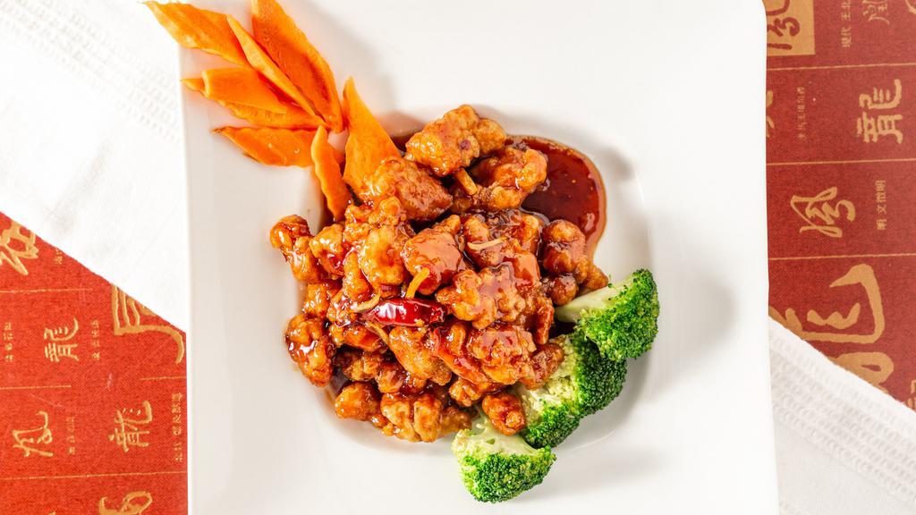Orange Chicken · Spicy. Chunks of crispy chicken with green onions, dry orange peels and chili peppers sautéed in a special brown sauce.