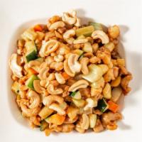 Cashew Chicken · Diced chicken, bamboo shoots, water chestnuts, celery, carrots, and cashews in a brown sauce.