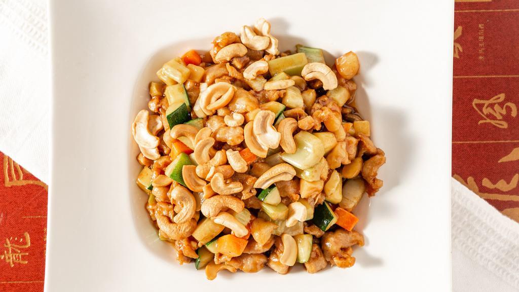 Cashew Chicken · Diced chicken, bamboo shoots, water chestnuts, celery, carrots, and cashews in a brown sauce.