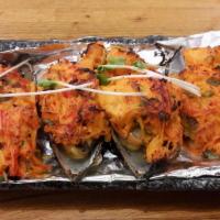 Tnt Mussels · Mussels topped with scallop, masago, scallion, crabmeat and house spicy sauce and broiled to...