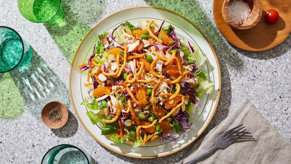 Chinese Chicken Salad · Shredded chicken over shredded cabbage and carrots with mandarin oranges, sesame seeds, green onions, chinese crispy noodles, edamame, and a sesame ginger dressing