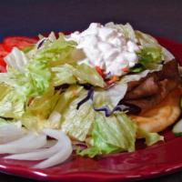 Greek Gyros · Seasoned lamb and beef
with sauce and salad.