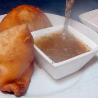 Samosa (2) With Raita · Spicy potato, green bean, and
onion filling in a pastry shell.