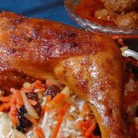 Kabuli Pilau · Baked chicken covered with Afghan rice, served with meatballs and yogurt.
