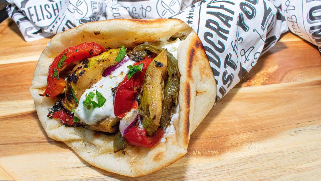 Vegetable Gyro · Grilled vegetable mix wrapped in Greek pita with tzatziki, tomato and onion (For Vegan ask us to substitute tzatziki for hummus)