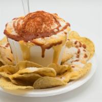 Elote Chorreado · Corn, mayonnaise, chili powder, butter, fresh lime, valentina sauce, tortilla chips, and che...