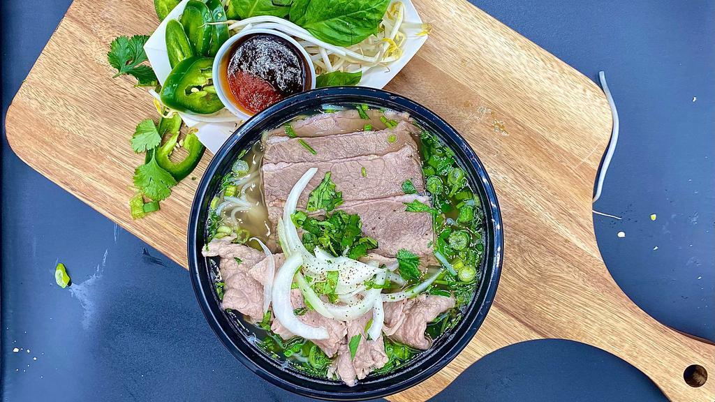 Pho-Ever · Authentic Vietnamese beef bone broth with rice noodles, medium rare steak and brisket, garnished with cilantro, scallions, and onions. Bean sprouts, thai basil and lime on the side. Siracha and hoisin sauce included on the side.