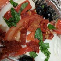 Caprese Salad · Buffalo fresh mozzarella, tomatoes, fresh basil, roasted peppers and olives.